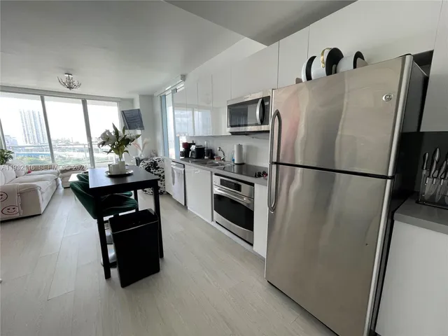 a kitchen with stainless steel appliances a refrigerator sink and stove