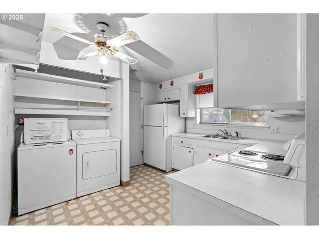 a kitchen with appliances cabinets and a counter top space