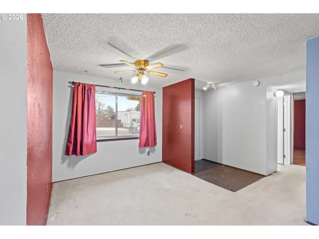 a view of an empty room with a fireplace