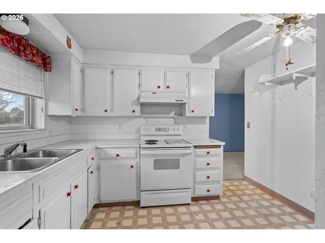 a kitchen with cabinets appliances and a sink