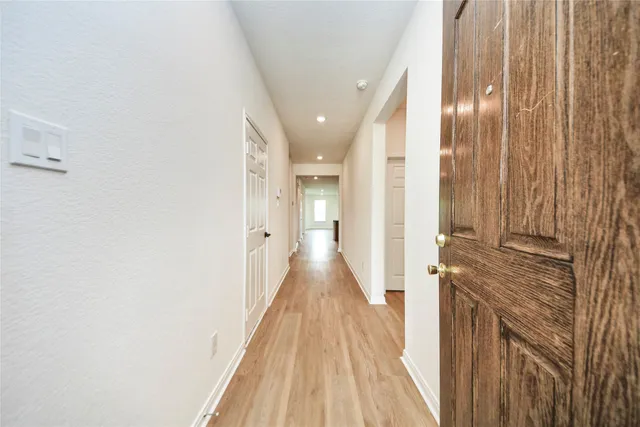 a large kitchen with stainless steel appliances granite countertop a stove a sink dishwasher a refrigerator and wooden floor