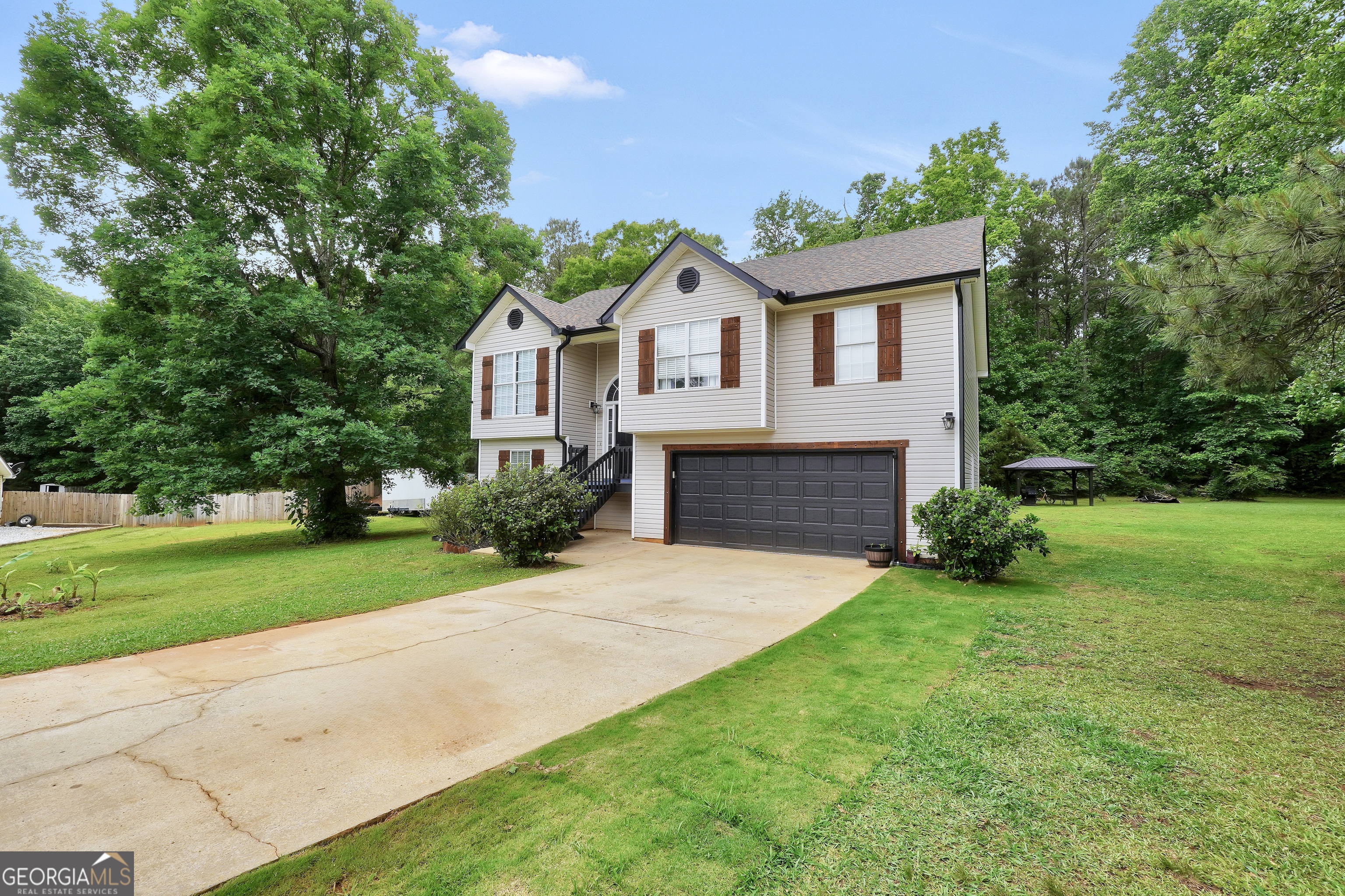 110 Westeria Way Jackson, GA 30233 - Photo 44 of 45 a front view of a house with a yard and garage