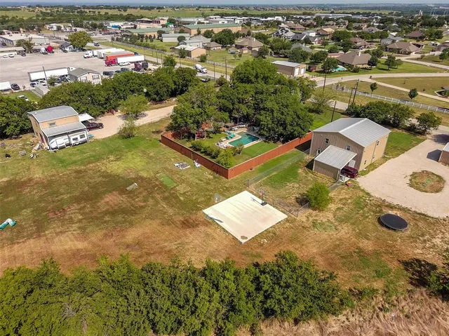 an aerial view of residential houses with outdoor space