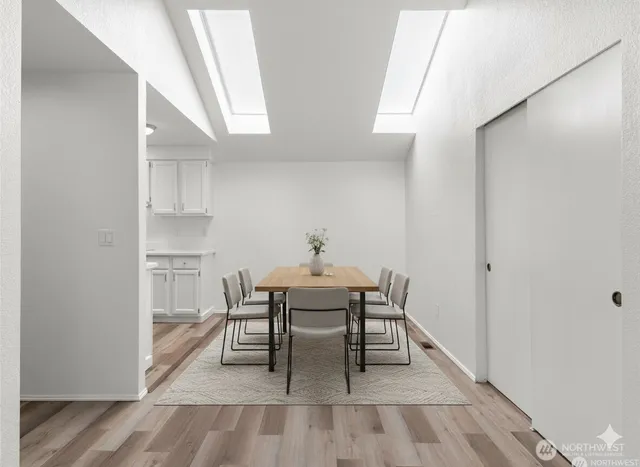 a dining room with furniture and wooden floor