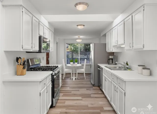 a kitchen with a sink stove and cabinets