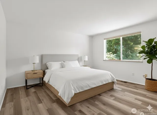 a bedroom with a bed and a window