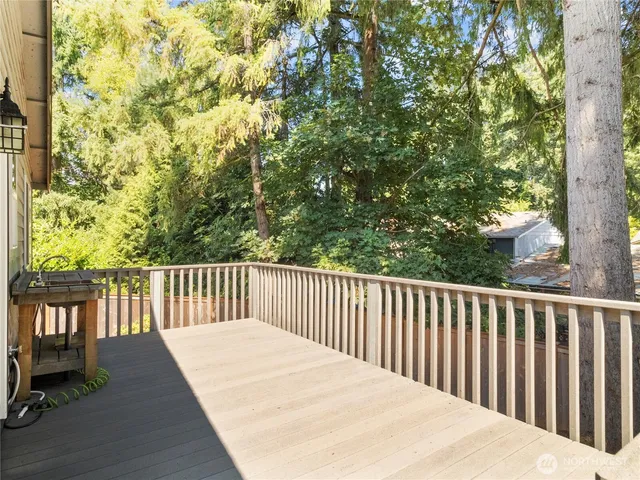 a balcony with wooden floor and fence