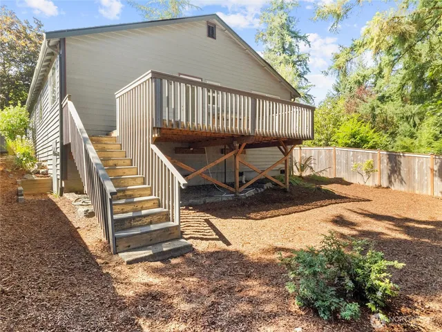 a view of balcony with wooden floor and outdoor seating