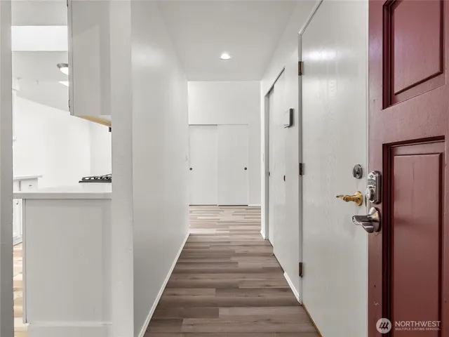 a view of a hallway with wooden floor and staircase