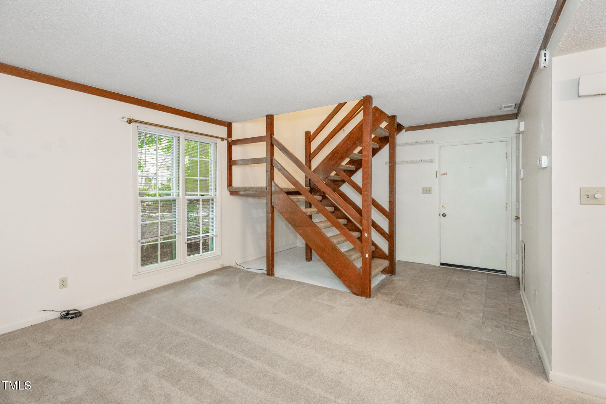 1809-1811 Quail Ridge Road Raleigh, NC 27609 - Photo 19 of 32 an empty room with wooden floor windows and a ceiling fan