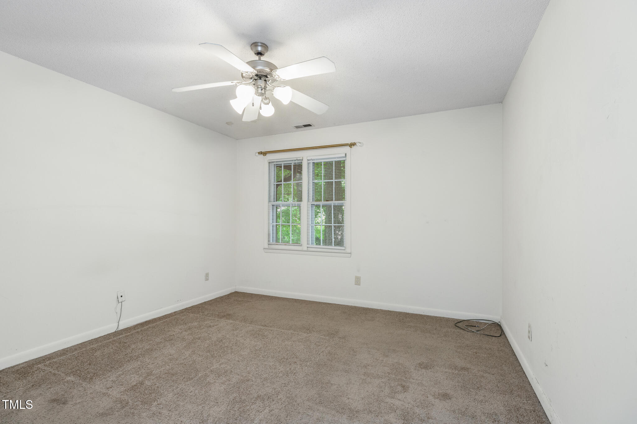 1809-1811 Quail Ridge Road Raleigh, NC 27609 - Photo 25 of 32 an empty room with windows and chandelier fan