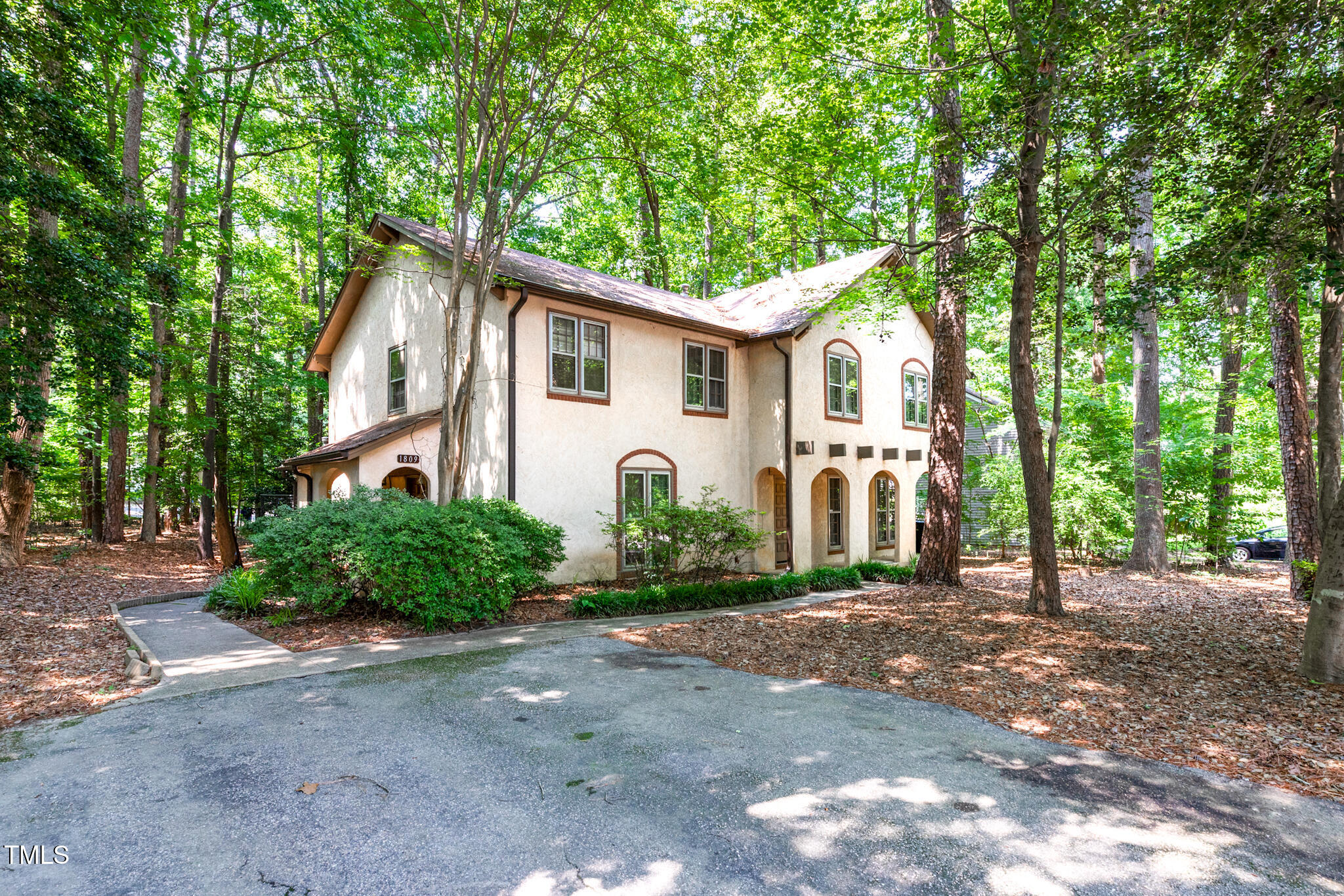 1809-1811 Quail Ridge Road Raleigh, NC 27609 - Photo 3 of 32 a front view of a house with garden