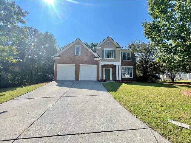a front view of a house with yard
