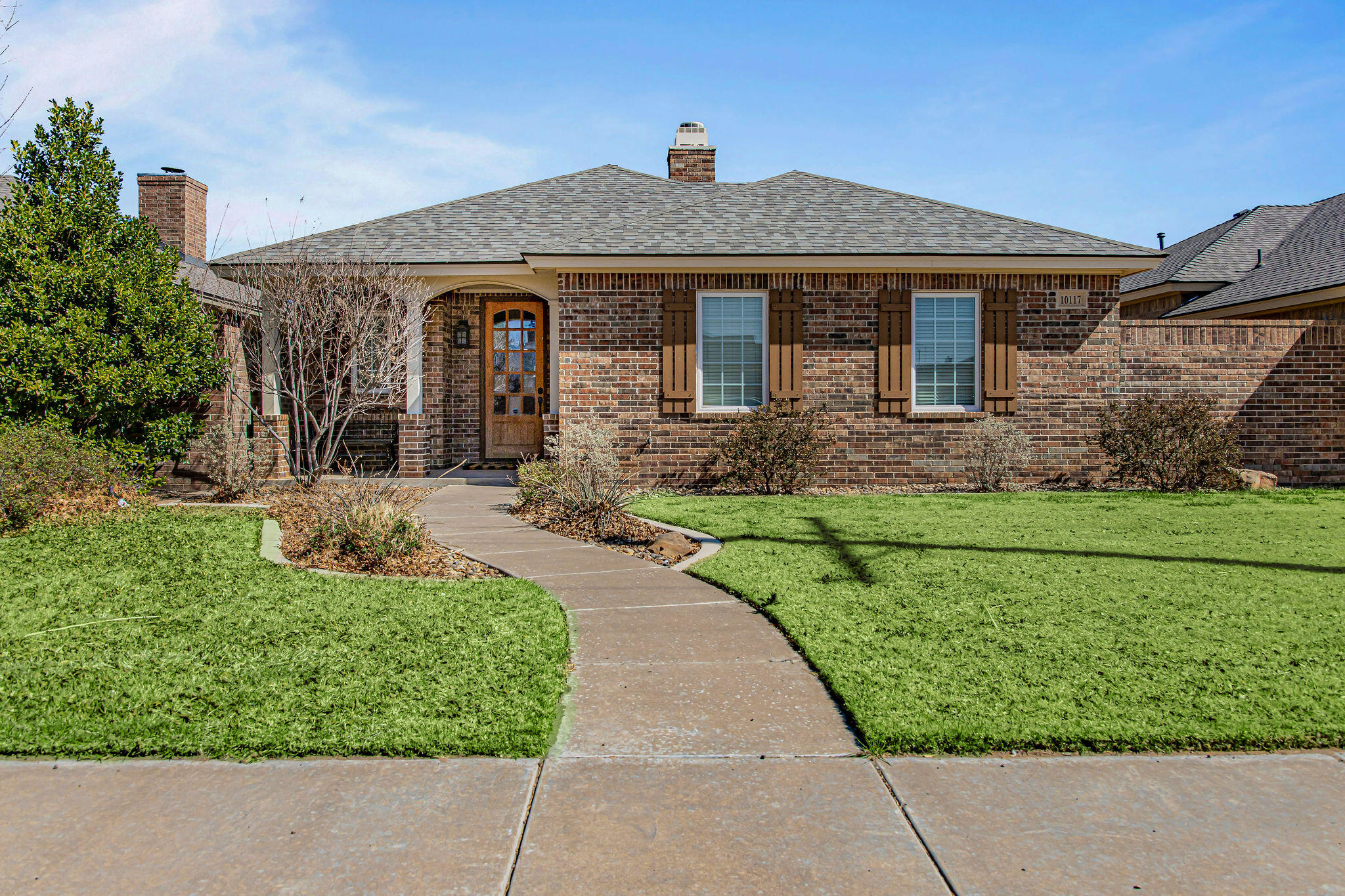 10117 Chicago Avenue Lubbock, TX 79424 - Photo 1 of 36 a front view of a house with a yard