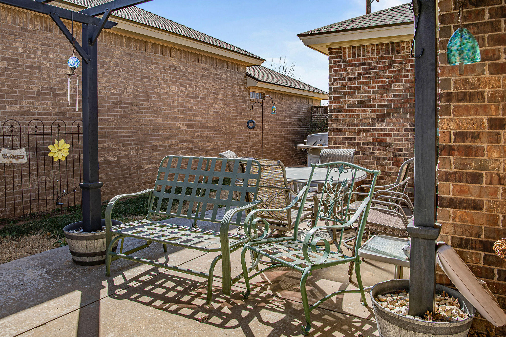 10117 Chicago Avenue Lubbock, TX 79424 - Photo 30 of 36 a view of a patio with table and chairs and potted plants