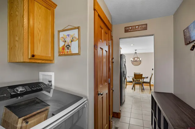 a kitchen with a table chairs and a refrigerator