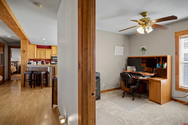 a view of a workspace with furniture and a window