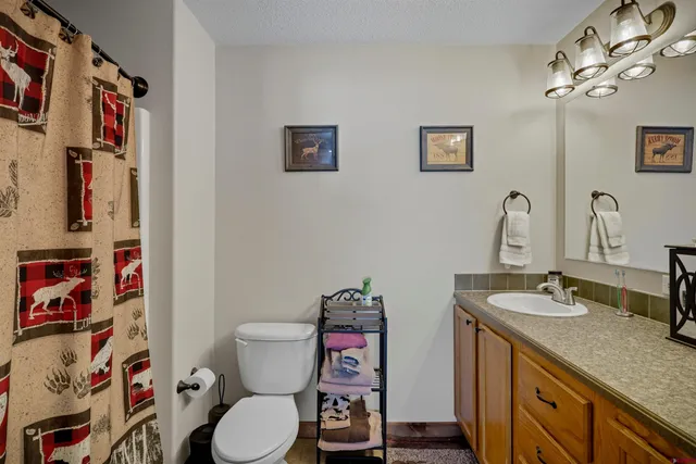 a bedroom with bed and wooden floor