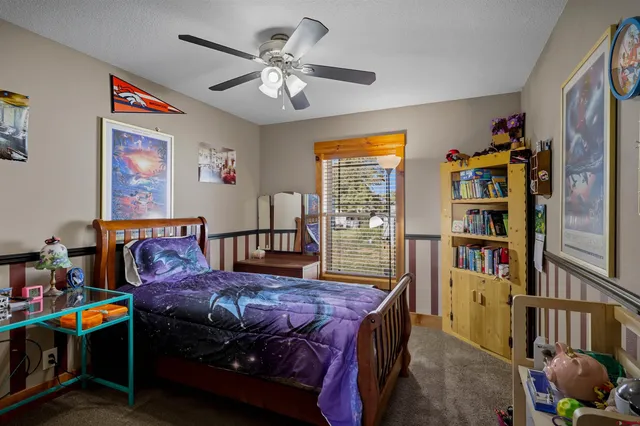 a bedroom with furniture and wooden floor