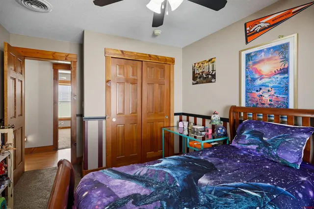 a bedroom with a bed and a mirror