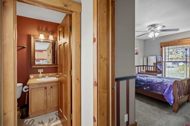 a bathroom with a toilet a sink and a mirror