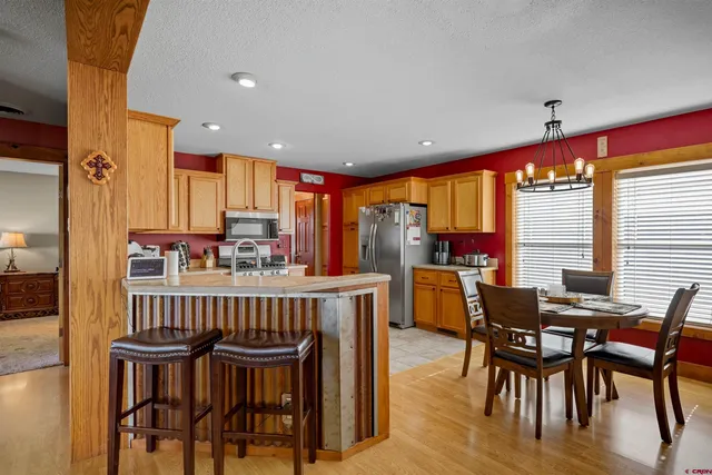 a living room with furniture a flat screen tv and a window