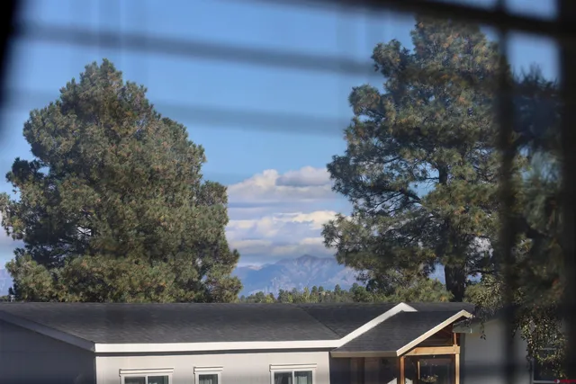a backyard of a house with yard and outdoor seating