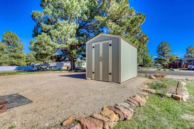 a backyard of a house with yard and outdoor seating