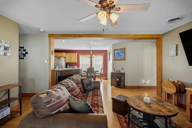 a kitchen with stainless steel appliances granite countertop a stove top oven a sink dishwasher and cabinets with wooden floor