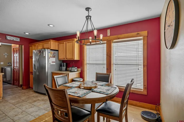 a kitchen with stainless steel appliances kitchen island granite countertop a refrigerator and wooden floor