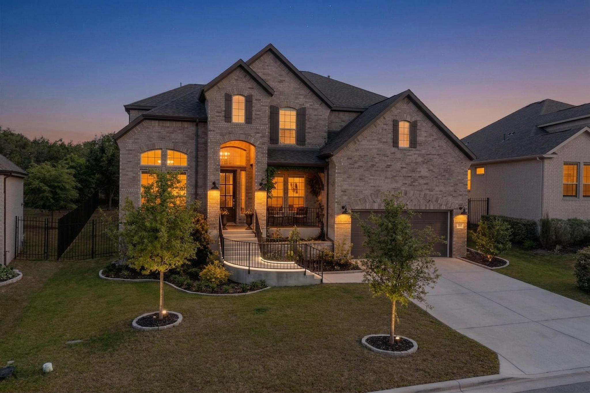 French country style house with brick siding, concrete driveway, and a garage