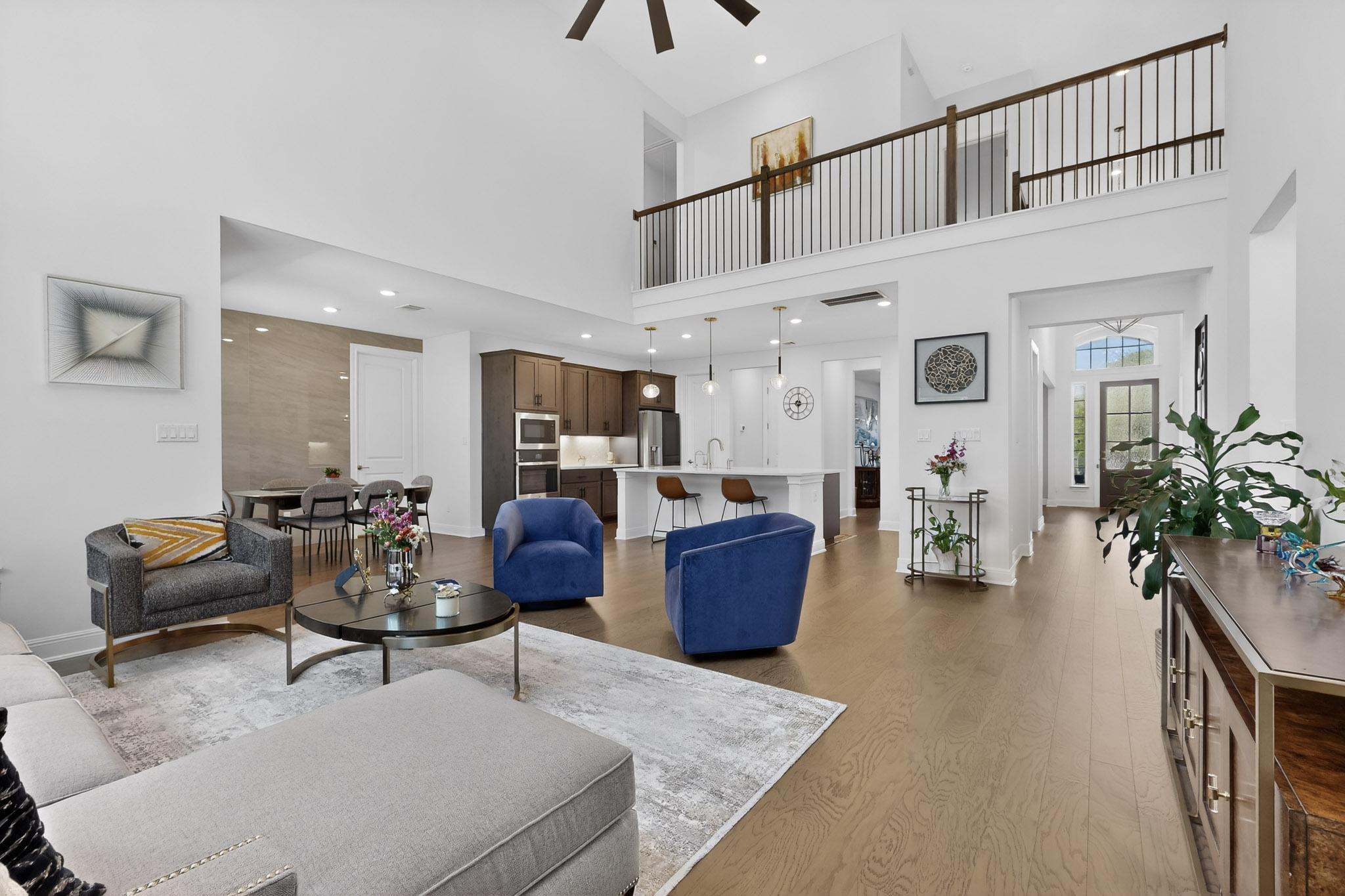 249 Running Bird Road Austin, TX 78737 - Photo 11 of 40 Living room with a ceiling fan, dark wood-style flooring, a high ceiling, and recessed lighting