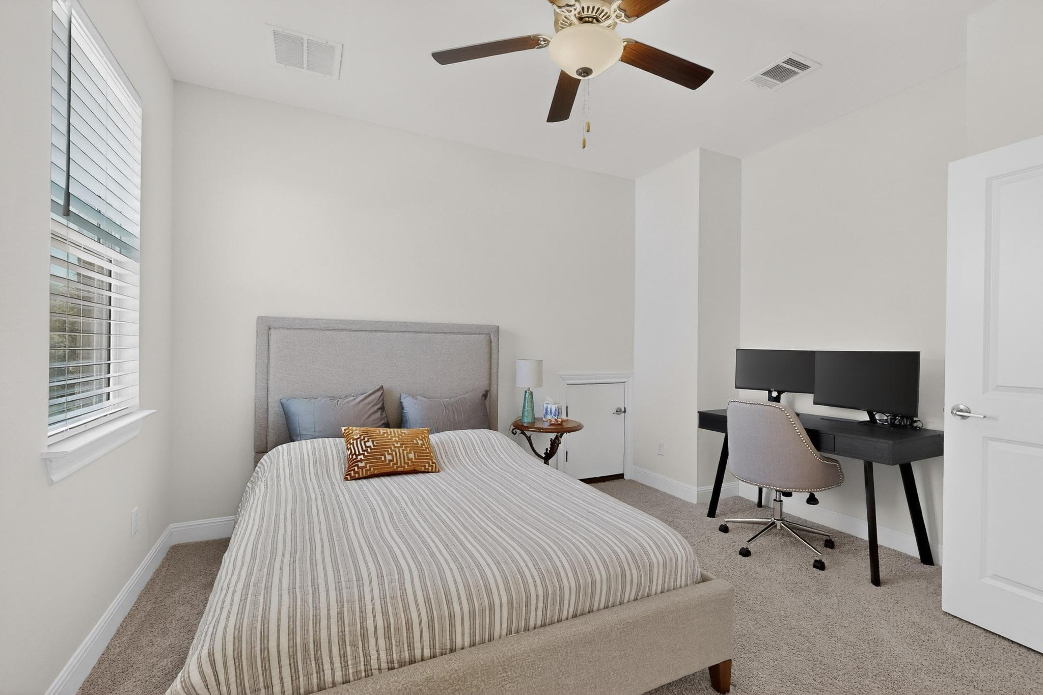 249 Running Bird Road Austin, TX 78737 - Photo 21 of 40 Bedroom featuring light carpet and ceiling fan