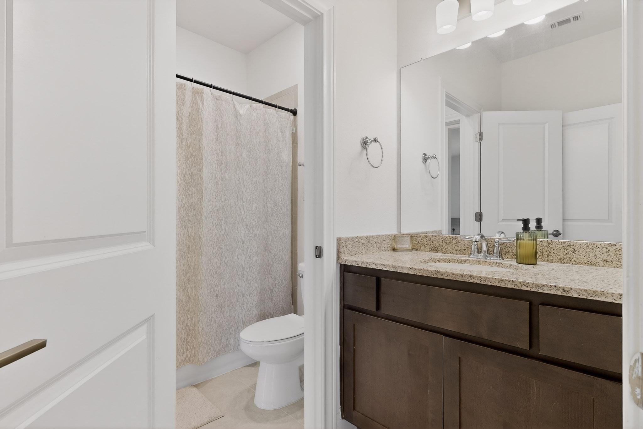 249 Running Bird Road Austin, TX 78737 - Photo 23 of 40 Full bath with vanity, curtained shower, and light tile patterned floors