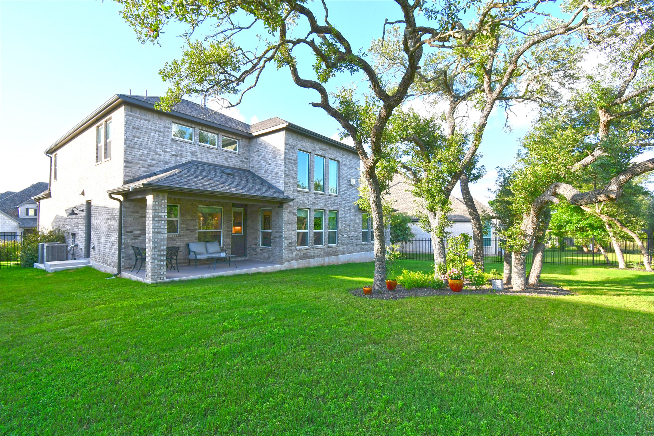 249 Running Bird Road Austin, TX 78737 - Photo 34 of 40 Back of house featuring a patio and brick siding