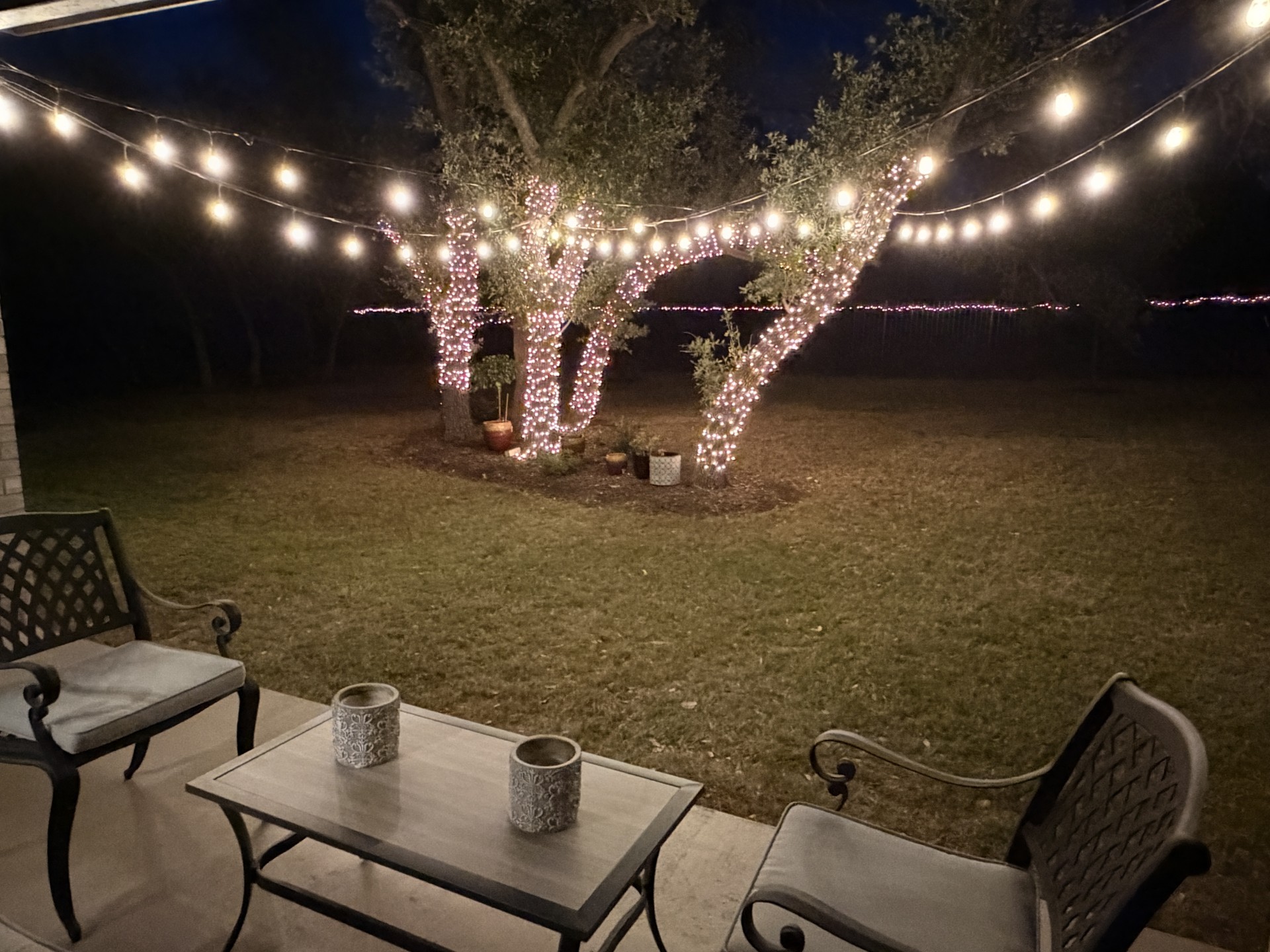 249 Running Bird Road Austin, TX 78737 - Photo 36 of 40 Patio at night with a lawn and a patio area
