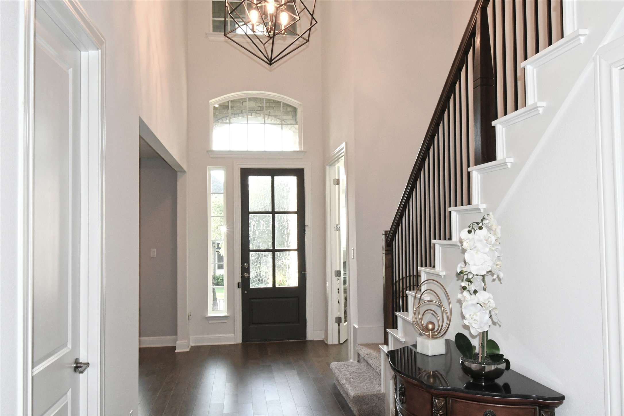249 Running Bird Road Austin, TX 78737 - Photo 5 of 40 Entryway featuring hanging lights, a high ceiling, and dark wood-style flooring