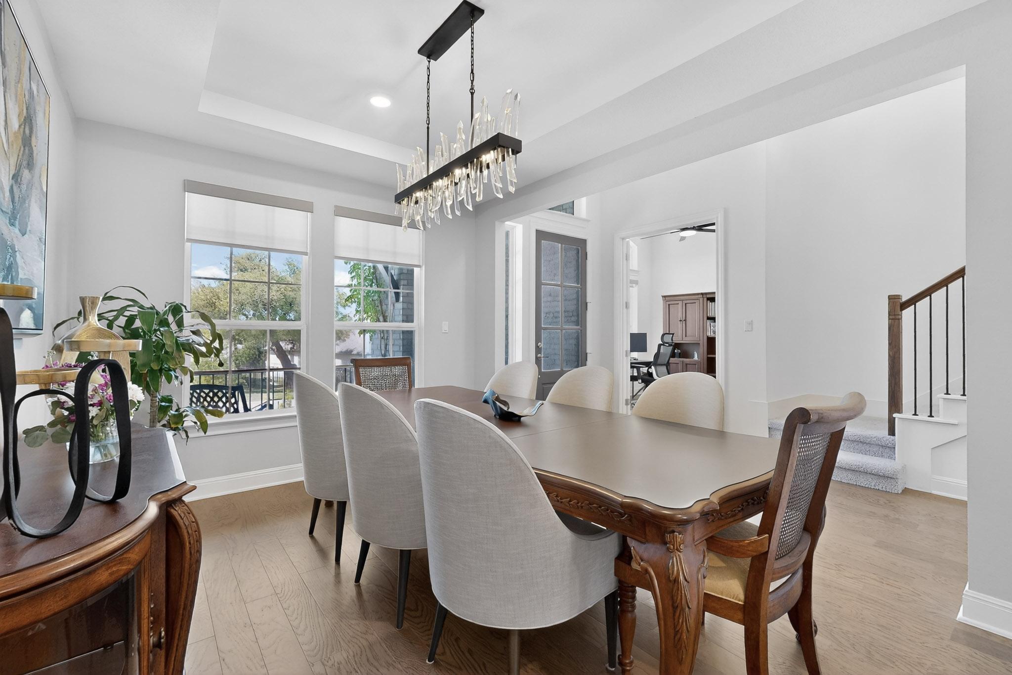 249 Running Bird Road Austin, TX 78737 - Photo 8 of 40 Dining Room featuring light wood-style floors, a raised ceiling, and recessed lighting