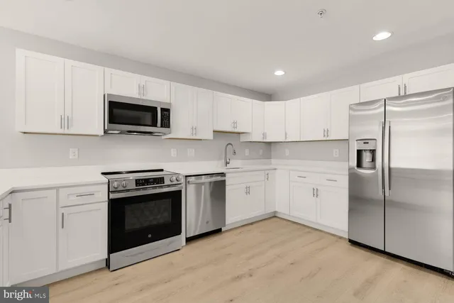 a kitchen with a refrigerator stove and microwave