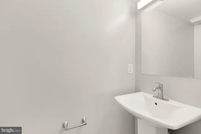 a bathroom with a sink and mirror