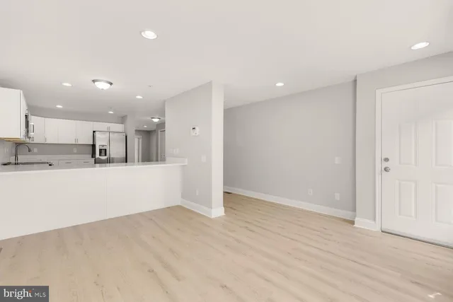 a view of kitchen with refrigerator and window