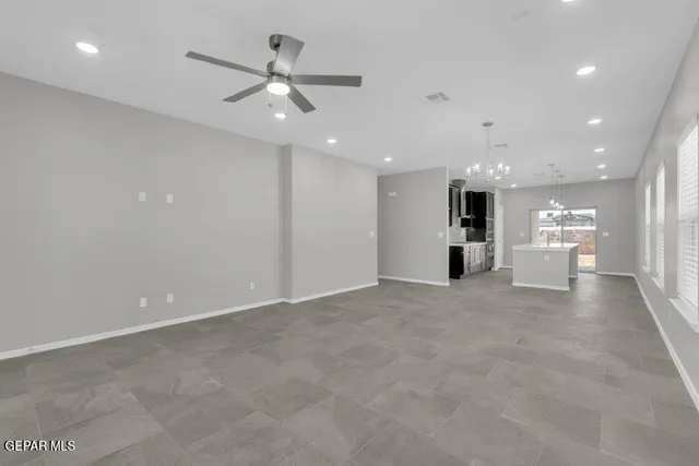 a view of a kitchen with a sink and a refrigerator