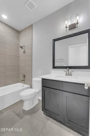 a bathroom with a toilet a sink a mirror and bathtub