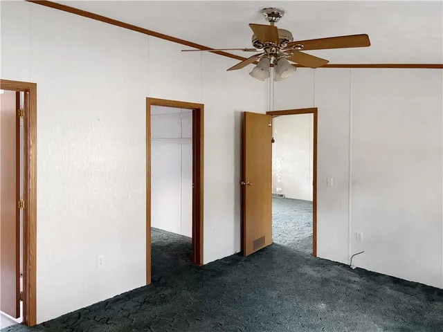 a view of a livingroom with a ceiling fan and a window