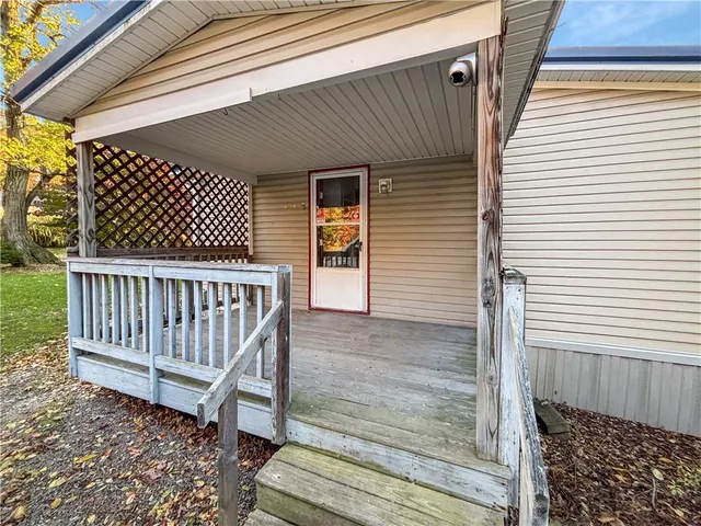 a view of a wooden door with a bench