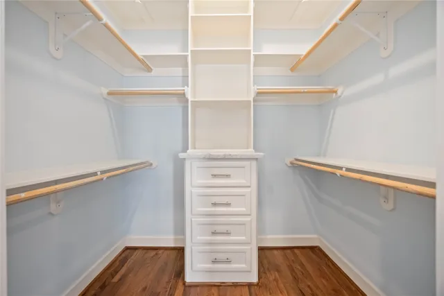 a view of walk in closet with empty racks
