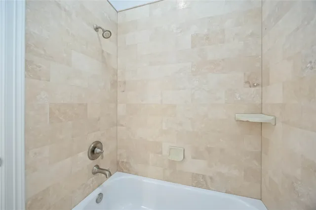 a bath tub sitting next to a white sink