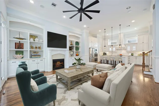 a living room with furniture a fireplace and a flat screen tv