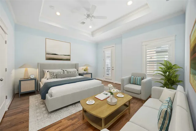 a spacious bedroom with a bed a couch and potted plant with the wooden floor