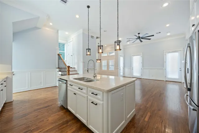 a kitchen with a sink and wooden floor